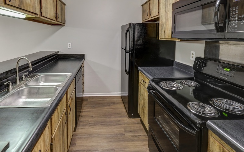 Galley kitchen with black appliances