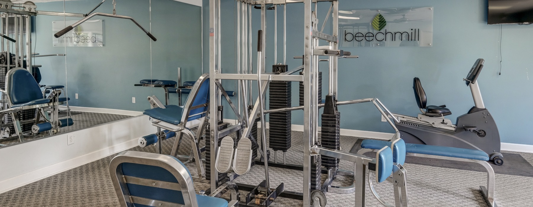 Gym with workout equipment and blue wall