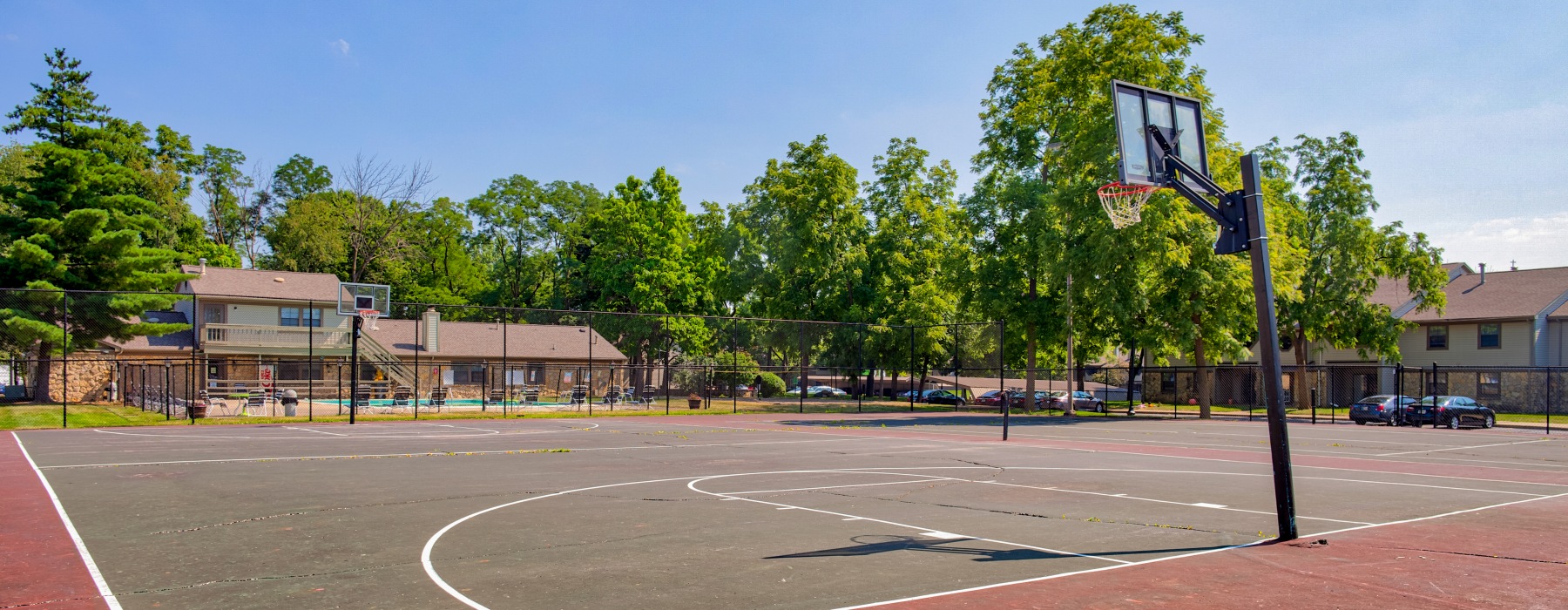 Outdoor basketball court with trees